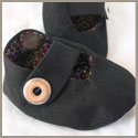 Black baby booties with snap closure